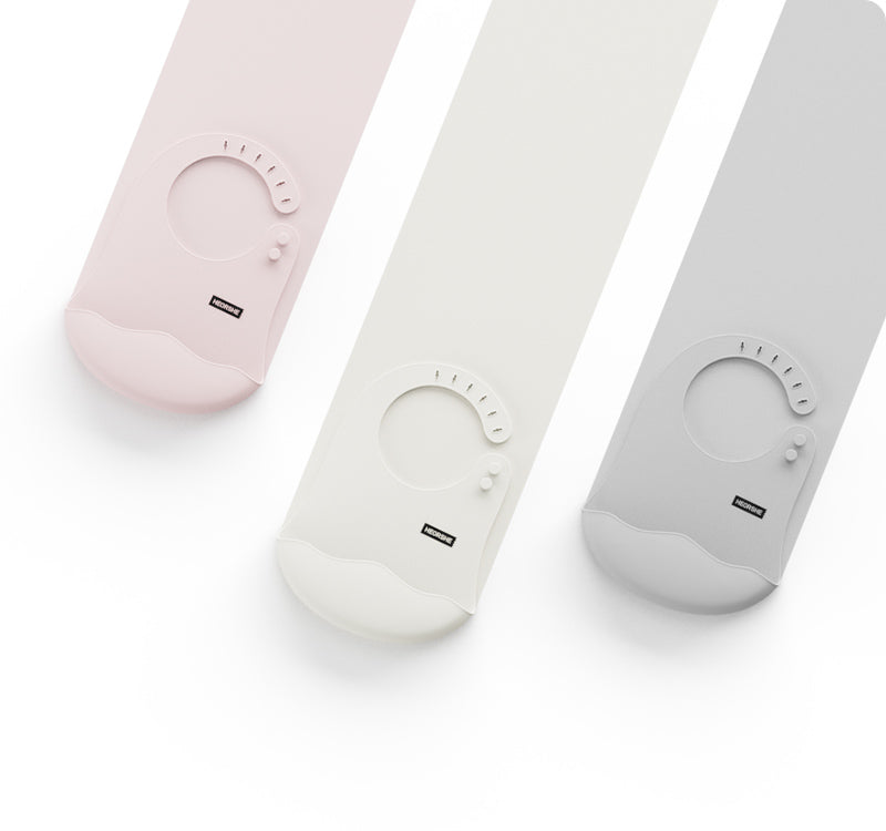 Three baby bibs in pink, white, and gray on a white background