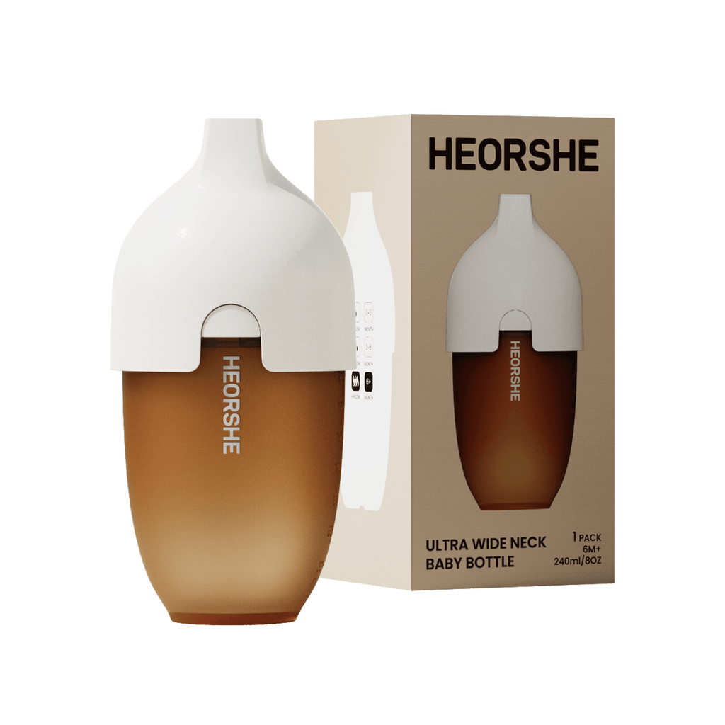 White and brown baby bottle with HEORSHE branding and packaging on a white background