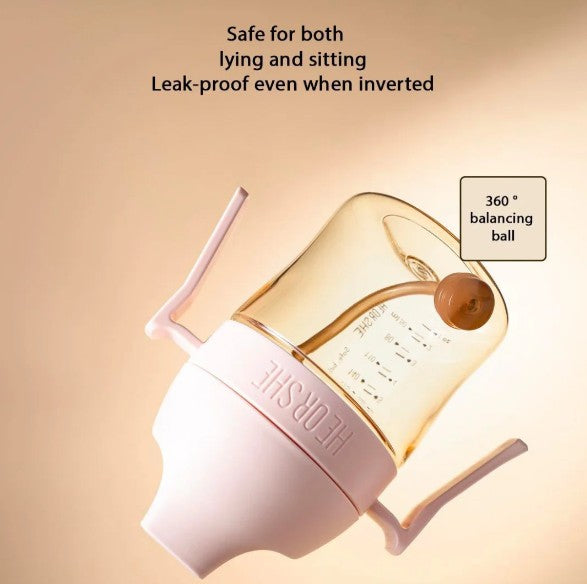 sippy cup with a balancing ball feature on a beige background