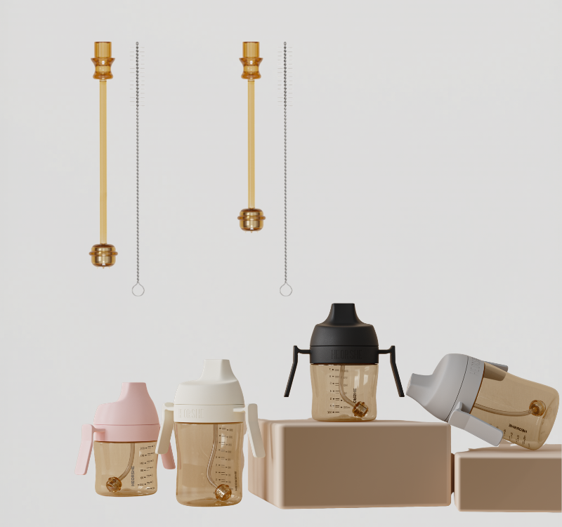Collection of sippy cups and accessories on a light gray background