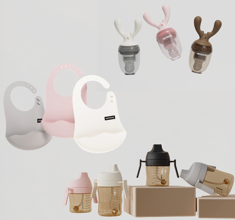 Collection of baby products including bibs and bottles on a light gray background