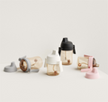 Set of variously colored water bottles sippy cusp on a light background