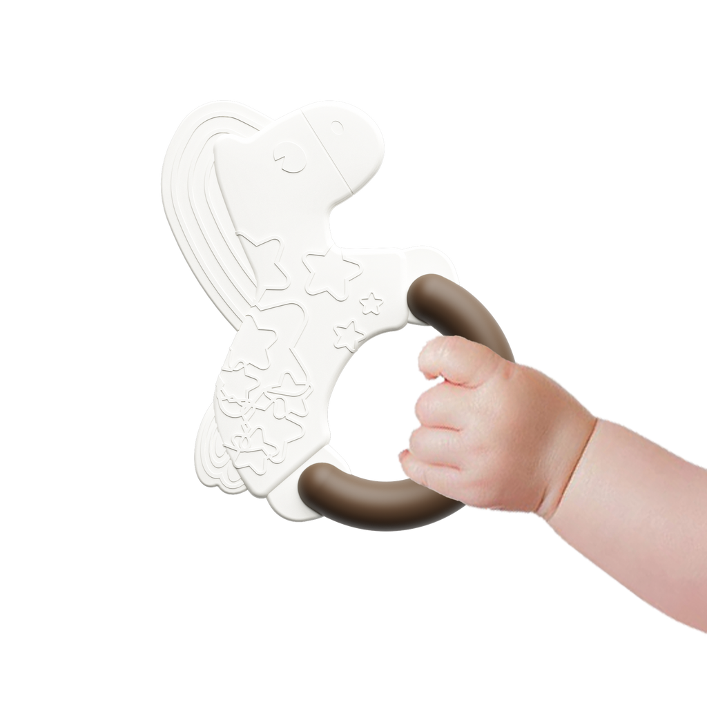 Baby hand holding a white and brown plastic toy rattle teether with dinosaur design on a white background